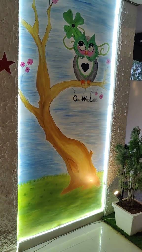 The original hand-painted owl mural at The Big Oowl Cafe